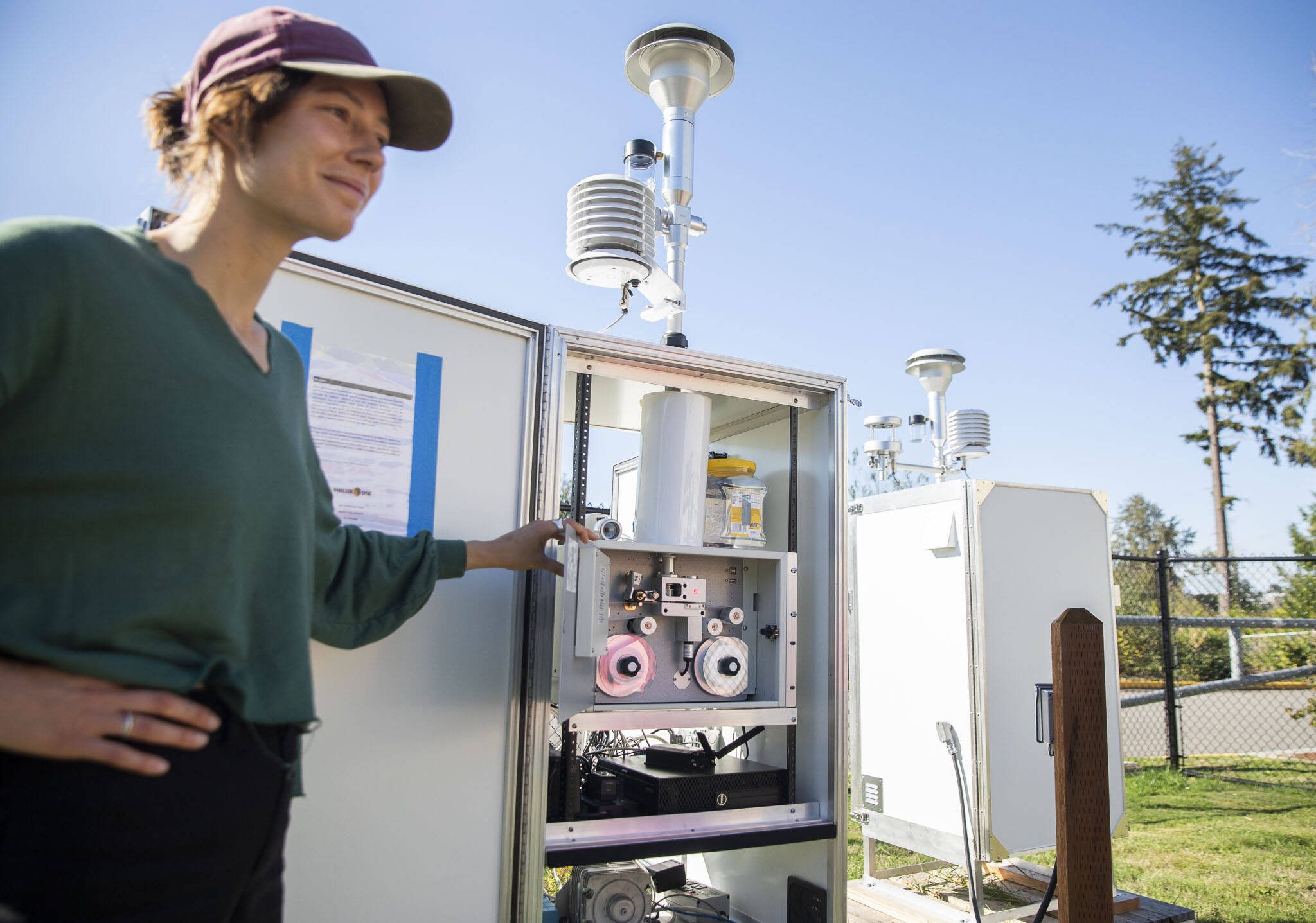 Kate Miller, an air monitoring specialist with the Department of Ecology, shows the inside of a PM10 air monitor installed outside of Fairmount Elementary School on Thursday, Sept. 5, 2024 in Everett, Washington. (Olivia Vanni / The Herald)