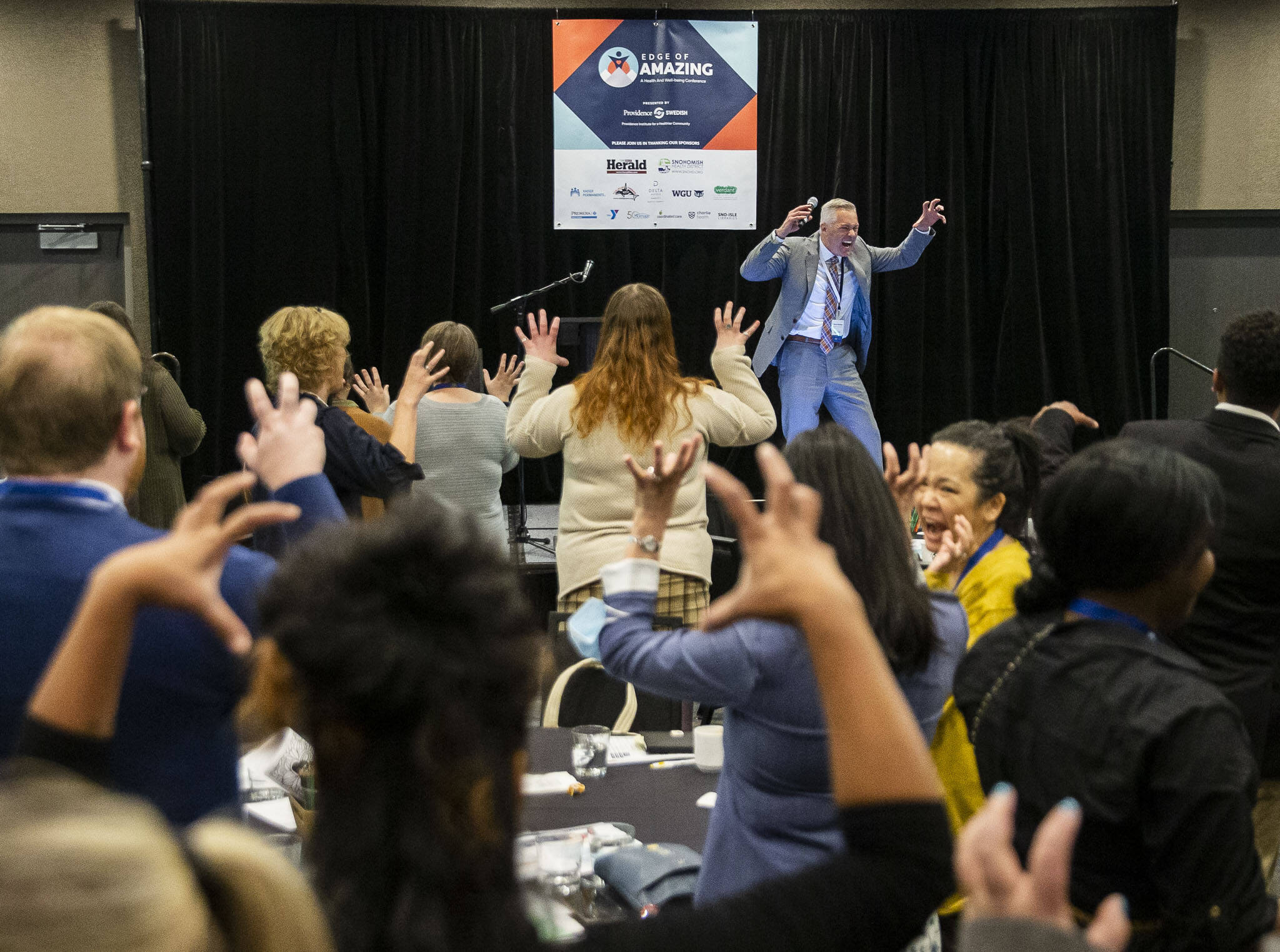 Director for the Snohomish County Health Department Dennis Worsham leads a short exercise during the Edge of Amazing event on Tuesday, Oct. 1, 2024 in Everett, Washington. (Olivia Vanni / The Herald)