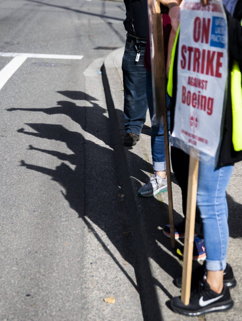 Boeing workers shadows are cast along Airport Road on Tuesday, Oct. 1, 2024 in Everett, Washington. (Olivia Vanni / The Herald)
