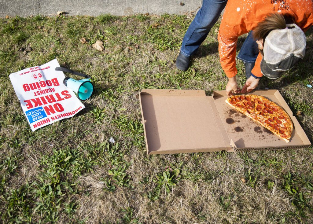 Pizza is delivered to Boeing workers workers on strike and picketing along Airport Road on Tuesday, Oct. 1, 2024 in Everett, Washington. (Olivia Vanni / The Herald)
