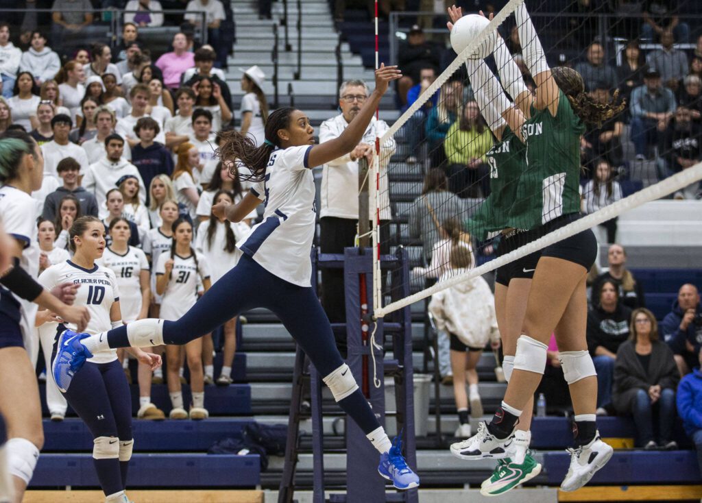 Glacier Peak’s Hanna Ligons tips the ball over the next during the game against Jackson on Wednesday, Sept. 25, 2024 in Snohomish, Washington. (Olivia Vanni / The Herald)
