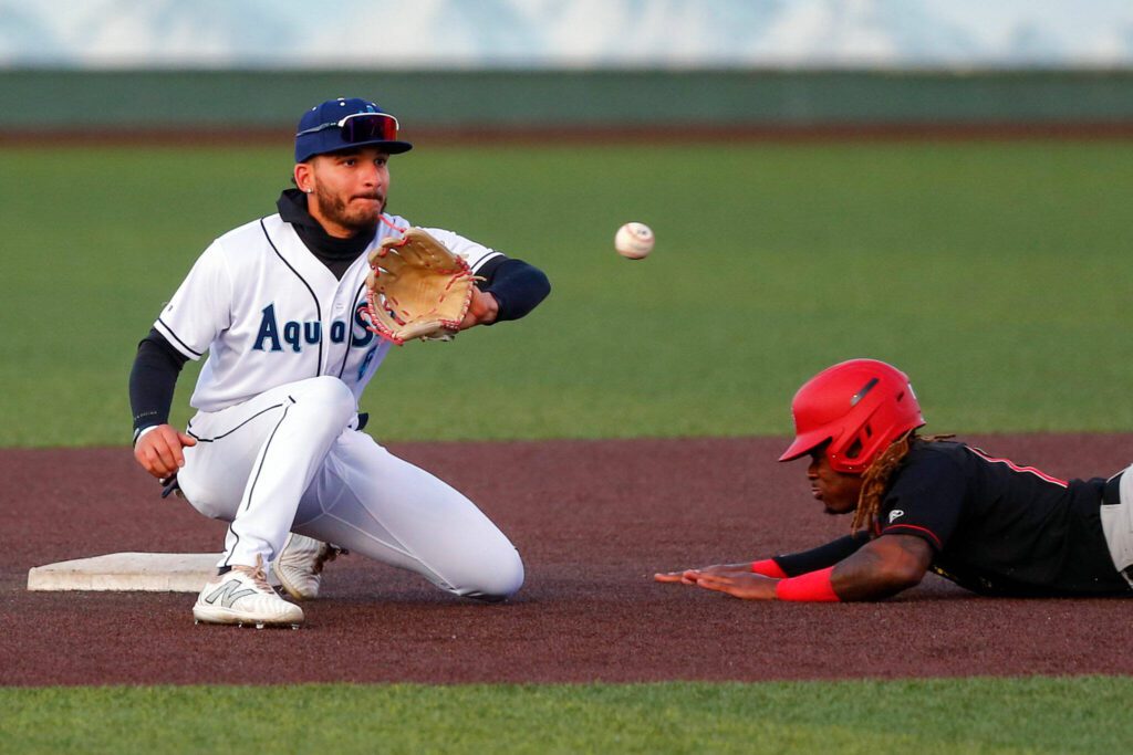Aquasox shortstop Axel Sanchez tries to tag out a base stealer during a game against the Vancouver Giants on Wednesday, June 5, 2024, at Funko Field in Everett, Washington. (Ryan Berry / The Herald)
