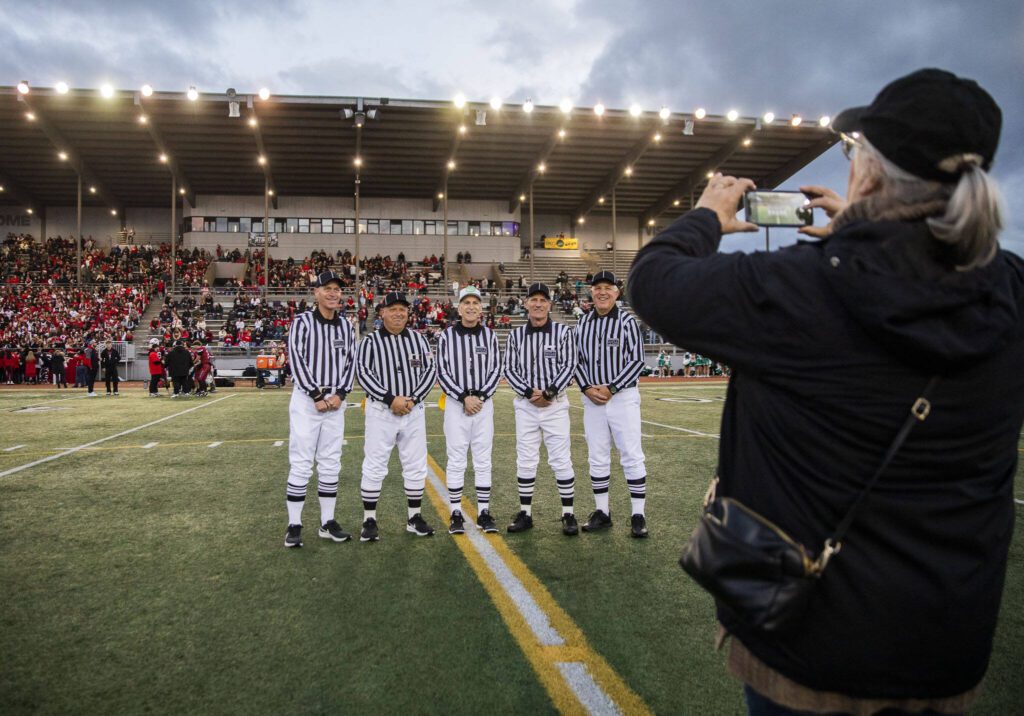 Steve Jensen (left to right) Ross Noe, Tom Freal, Jim Brotten and Dean Corcoran gather for a group photo before the start of the football game on Friday, Oct. 4, 2024 in Snohomish, Washington. (Olivia Vanni / The Herald)
