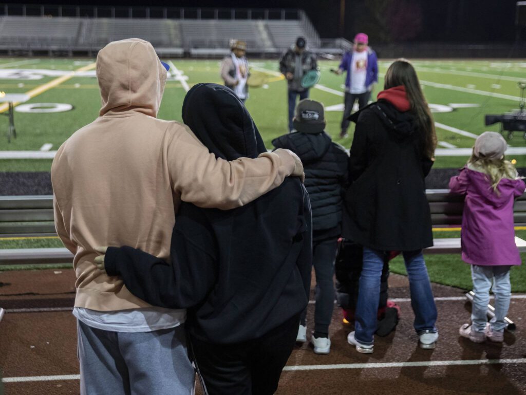 Community members, family and friends of those lost in the Marysville Pilchuck High School shooting listen to a song to conclude the memorial on Thursday, Oct. 24, 2024 in Marysville, Washington. (Olivia Vanni / The Herald)
