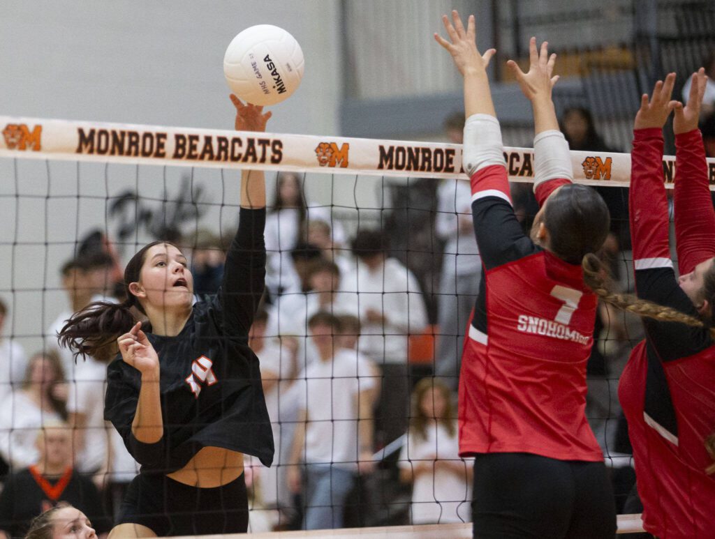 Monroe’s Kiah Dunbar tips the ball over the top of the net during the game against Snohomish on Wednesday, Oct. 16, 2024 in Monroe, Washington. (Olivia Vanni / The Herald)
