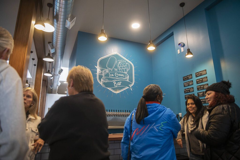 People gather for the grand opening of The Ice Cream Bar on Friday, Oct. 18, 2024 in Everett, Washington. (Olivia Vanni / The Herald)

