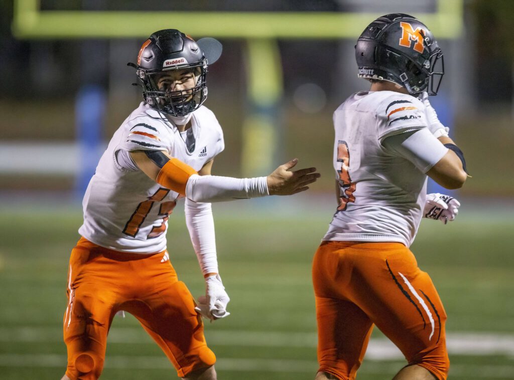 Monroe’s Zane Osborn congratulates his teammate Aaron Clifton on his touchdown during the game against Shorecrest on Friday, Oct. 18, 2024 in Shoreline, Washington. (Olivia Vanni / The Herald)
