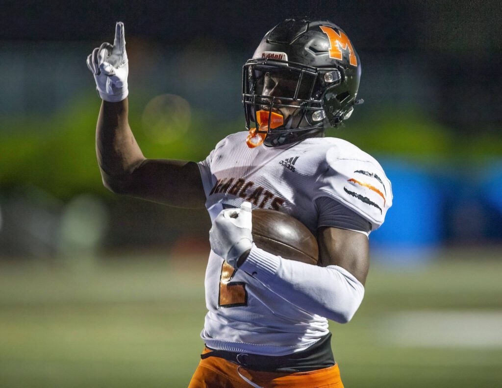 Monroe’s Carl Watson III points his finger in the air as he runs the ball into the end zone for a touchdown during the game against Shorecrest on Friday, Oct. 18, 2024 in Shoreline, Washington. (Olivia Vanni / The Herald)
