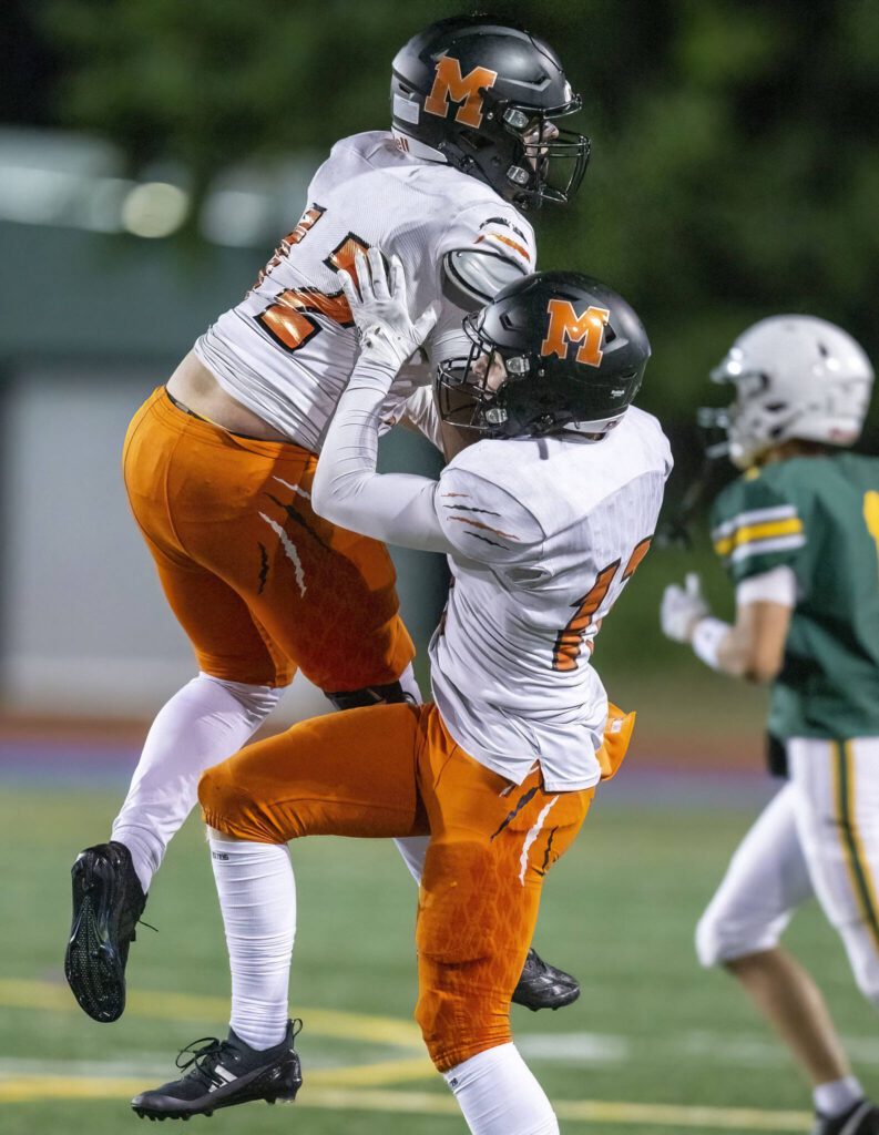 Monroe players celebrate getting a stop on 4th down during the game against Shorecrest on Friday, Oct. 18, 2024 in Shoreline, Washington. (Olivia Vanni / The Herald)
