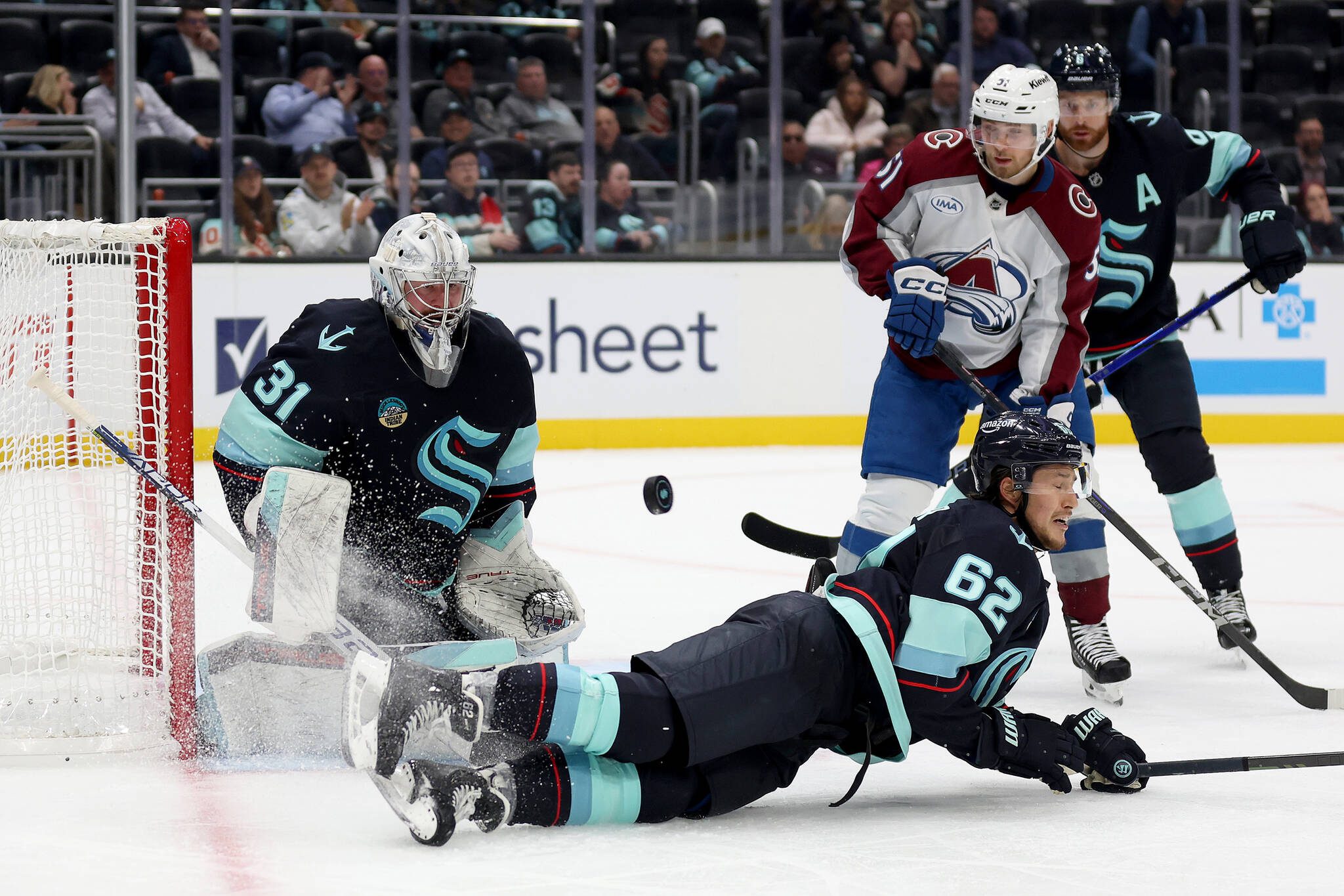The Seattle Kraken’s Brandon Montour (62) attempts to block a shot in front of goaltender Philipp Grubauer (31) during the third period against the Colorado Avalanche at Climate Pledge Arena on Tuesday, Oct. 22, 2024, in Seattle. (Steph Chambers / Getty Images / Tribune News Services)