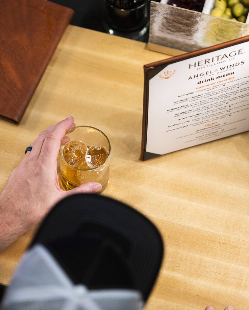 A person enjoys at drink at the bar at the new Heritage Distillery tasting room at Angel of the Winds Casino on Friday, Oct. 25, 2024 in Arlington, Washington. (Olivia Vanni / The Herald)
