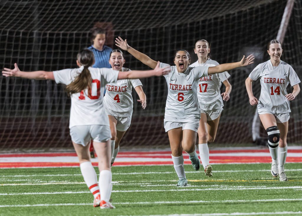 Mountlake Terrace players run toward each other to celebrate after scoring a goal during the 3A district game against Stanwood on Thursday, Oct. 31, 2024 in Stanwood, Washington. (Olivia Vanni / The Herald)
