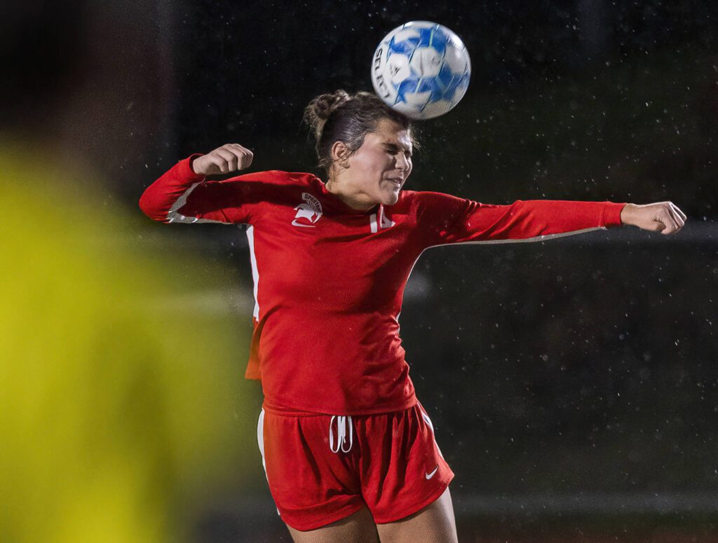 Stanwood’s Amelia Allen heads the ball during the 3A district game against Mountlake Terrace on Thursday, Oct. 31, 2024 in Stanwood, Washington. (Olivia Vanni / The Herald)
