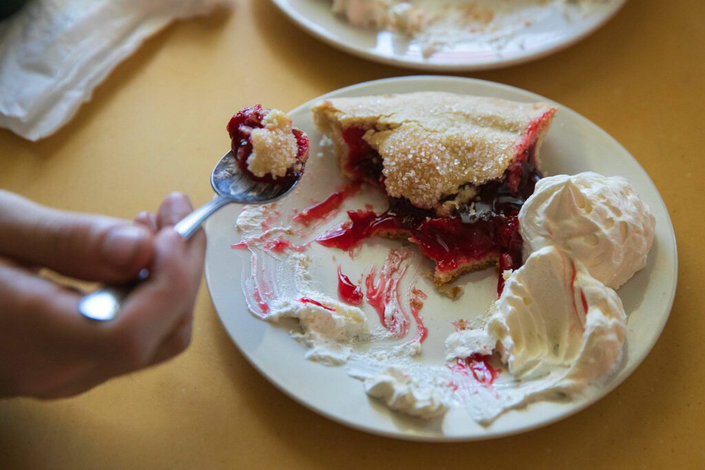 A pair of diners split some cherry pie, the most popular item at Twede’s Cafe, on Sunday, June 9, 2024, in North Bend, Washington. (Ryan Berry / The Herald)
