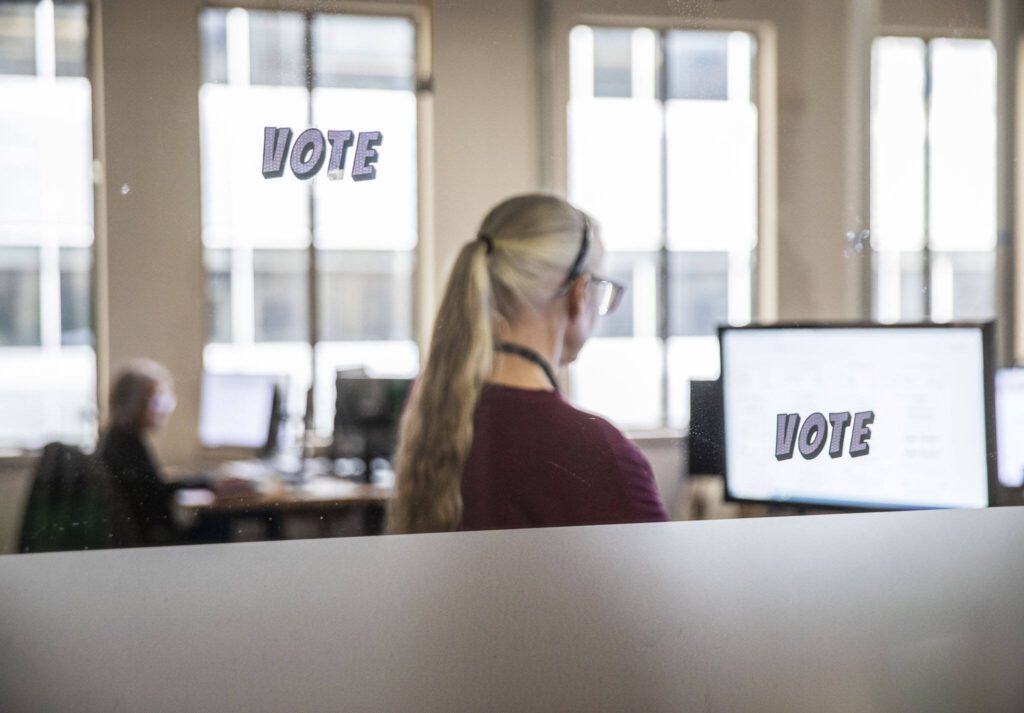 Snohomish County Elections employees check signatures on ballots on Tuesday, Oct. 29, 2024 in Everett , Washington. (Olivia Vanni / The Herald)
