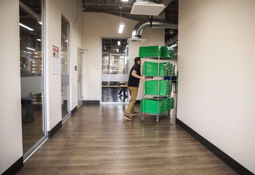 Empty ballots bins are moved down a hallway at Snohomish County Elections on Tuesday, Oct. 29, 2024 in Everett , Washington. (Olivia Vanni / The Herald)

