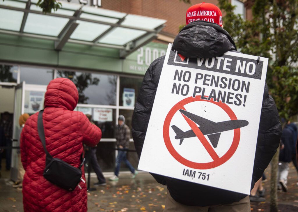 Larry Best, a customer coordinator for quality assurance who has worked at Boeing for 38 years, stands outside of Angel of the Winds Arena with a “vote no” sign on Monday, Nov. 4, 2024 in Everett, Washington. (Olivia Vanni / The Herald)

