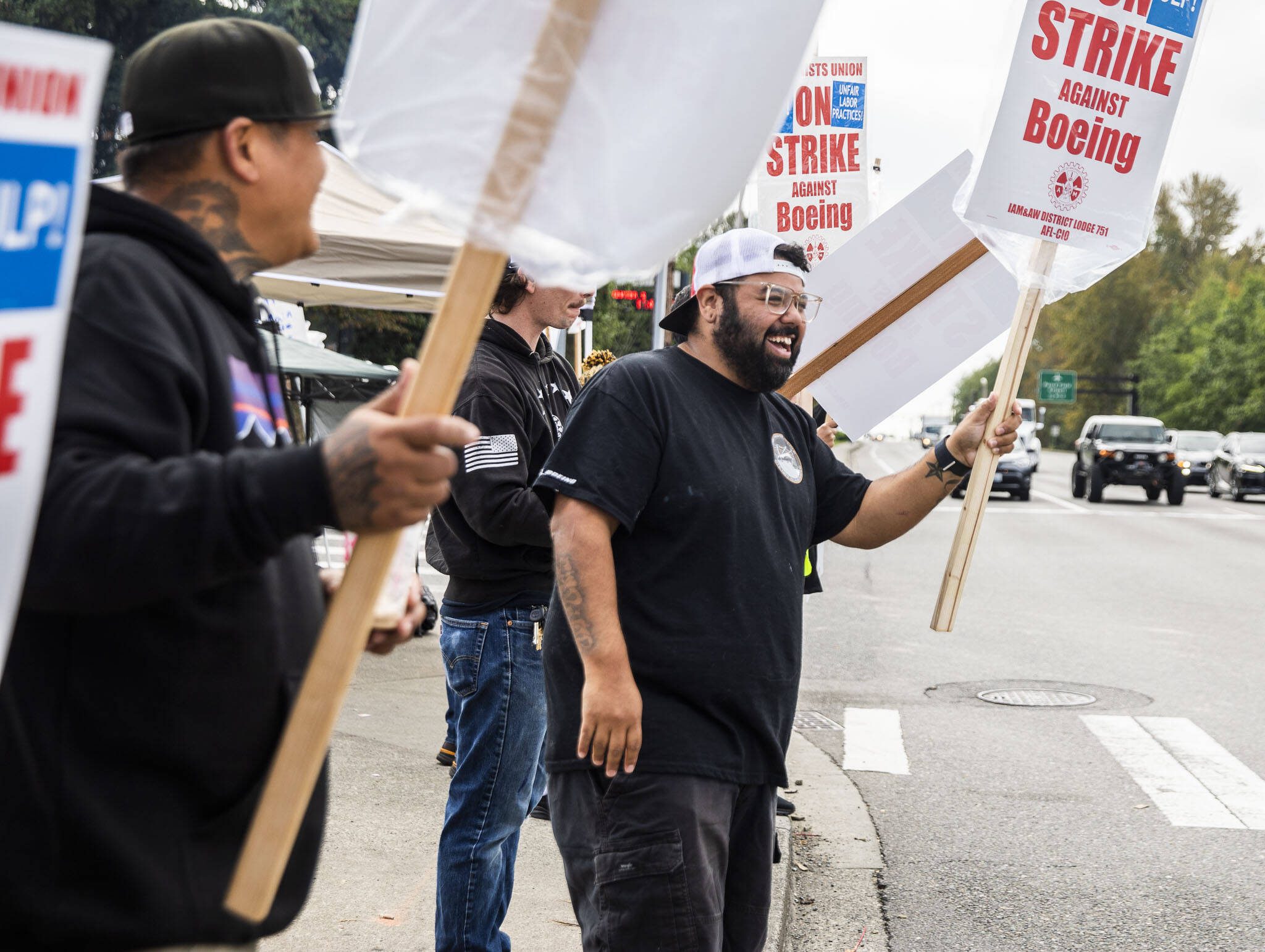 Matt Saldivar, a lead mechanic at Boeing for 5 years, pickets with other Boeing workers on strike on Sept. 16 in Everett. (Olivia Vanni / The Herald)