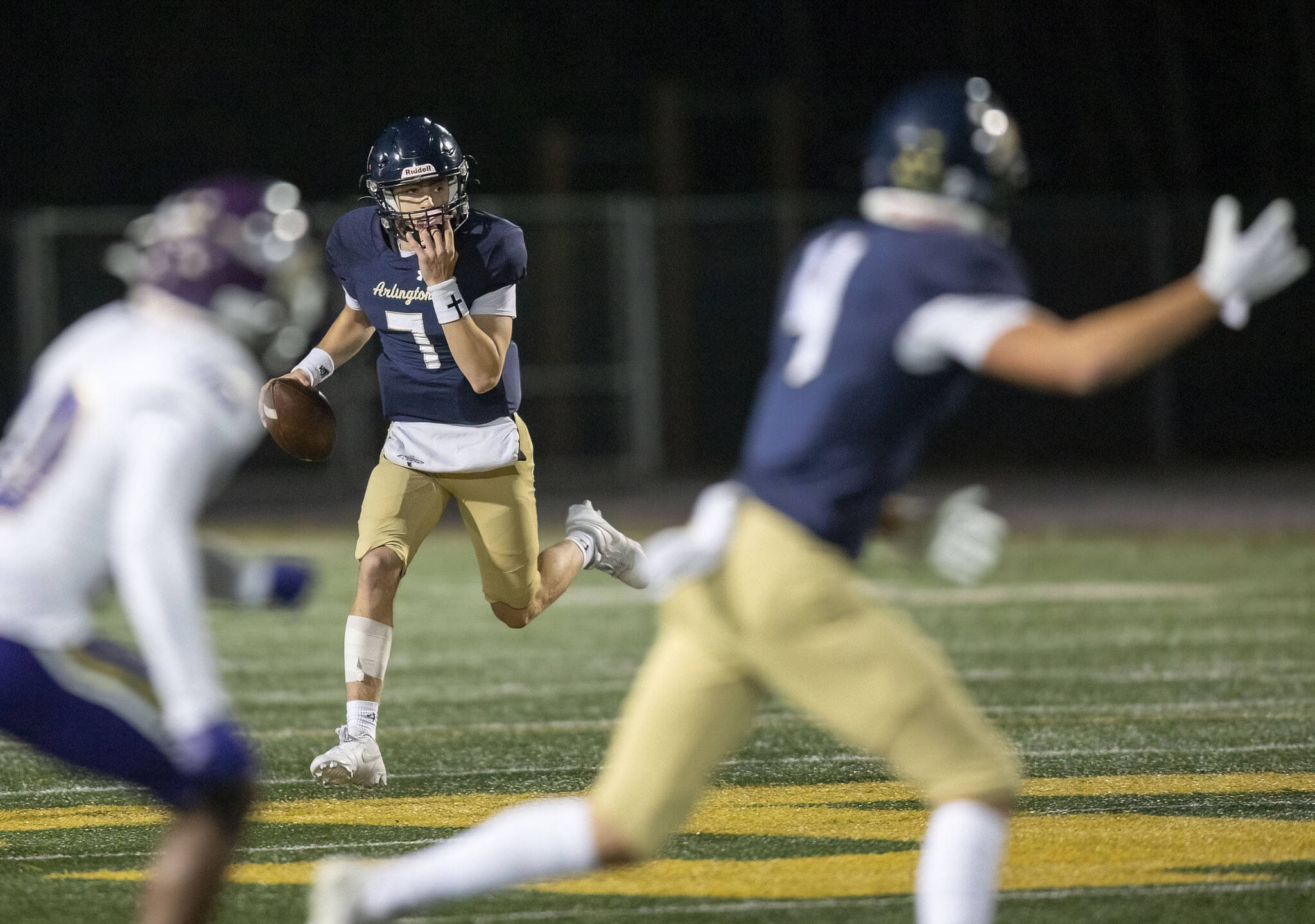 Arlington’s Leyton Martin scrambles and looks for a teammate to pass to during the game against Lake Stevens on Friday, Nov. 1, 2024 in Arlington, Washington. (Olivia Vanni / The Herald)