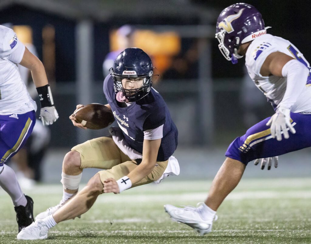 Arlington’s Leyton Martin slides to the ground while running with the ball during the game against Lake Stevens on Friday, Nov. 1, 2024 in Arlington, Washington. (Olivia Vanni / The Herald)
