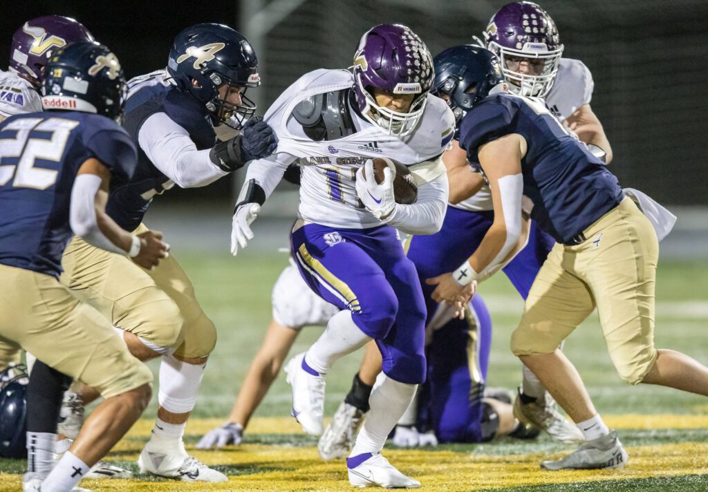 Lake Stevens’ Cannon Kennard has his jersey pulled while running the ball during the game against Arlington on Friday, Nov. 1, 2024 in Arlington, Washington. (Olivia Vanni / The Herald)
