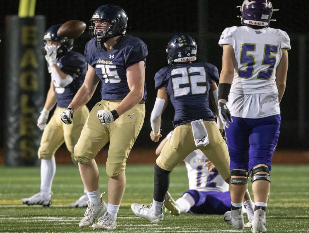 Arlington’s DK Kendrick celebrates getting a sack during the game against Lake Stevens on Friday, Nov. 1, 2024 in Arlington, Washington. (Olivia Vanni / The Herald)
