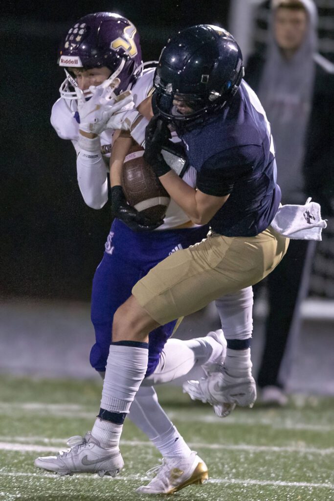 Arlington’s Eli Rae picks off a pass during the game against Lake Stevens on Friday, Nov. 1, 2024 in Arlington, Washington. (Olivia Vanni / The Herald)
