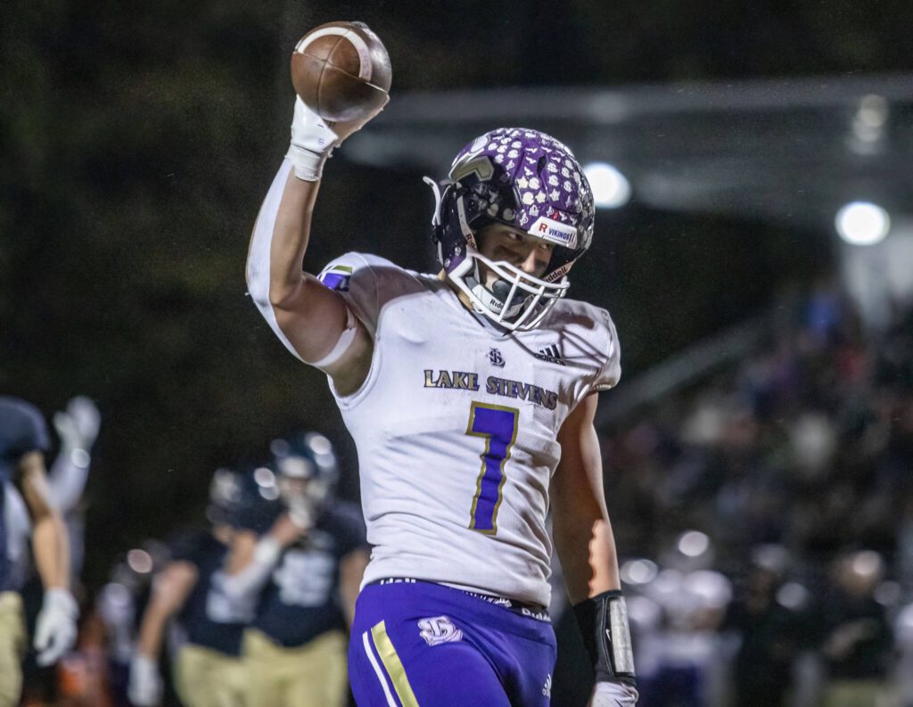 Lake Stevens’ Keagan Howard raises the ball in the air in celebration after running into the end zone for a touchdown during the game against Arlington on Friday, Nov. 1, 2024 in Arlington, Washington. (Olivia Vanni / The Herald)
