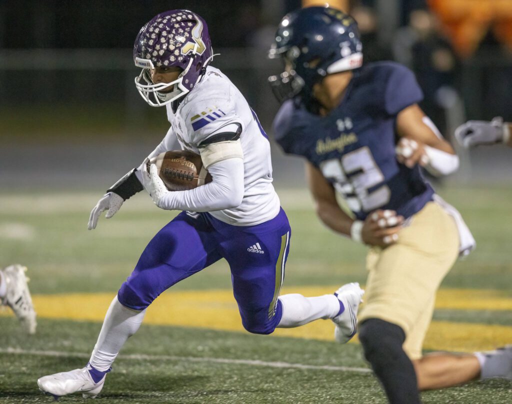 Lake Stevens’ Jayshon Limar runs the ball during the game against Arlington on Friday, Nov. 1, 2024 in Arlington, Washington. (Olivia Vanni / The Herald)
