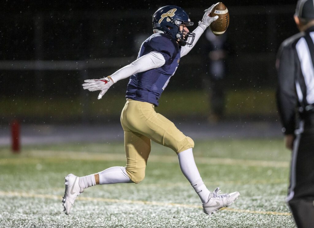 Arlington’s Kaid Hunter runs the ball into the end zone for a touchdown during the game against Lake Stevens on Friday, Nov. 1, 2024 in Arlington, Washington. (Olivia Vanni / The Herald)
