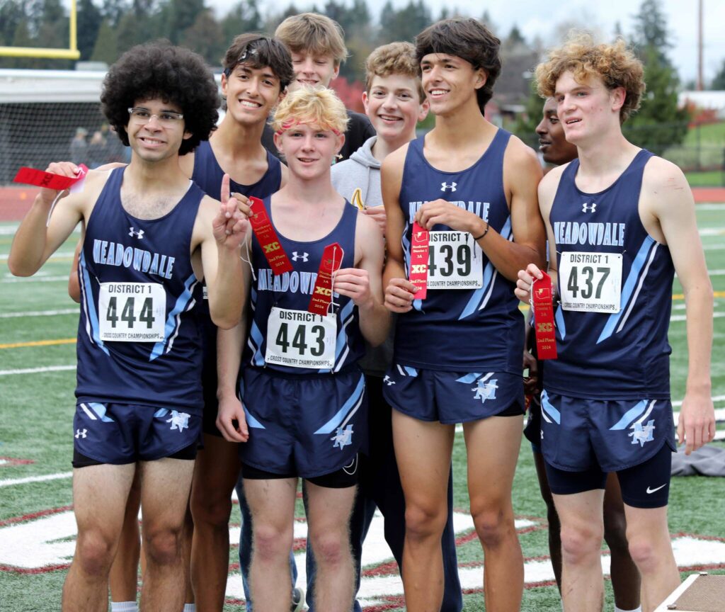 Members of the Meadowdale High School boys cross country team pose for a photo at the District 1/2 Cross Country Championships at Lakewood High School in Arlington, Wash., on Nov. 2, 2024. The Mavericks finished second in 3A. (Taras McCurdie / The Herald)
