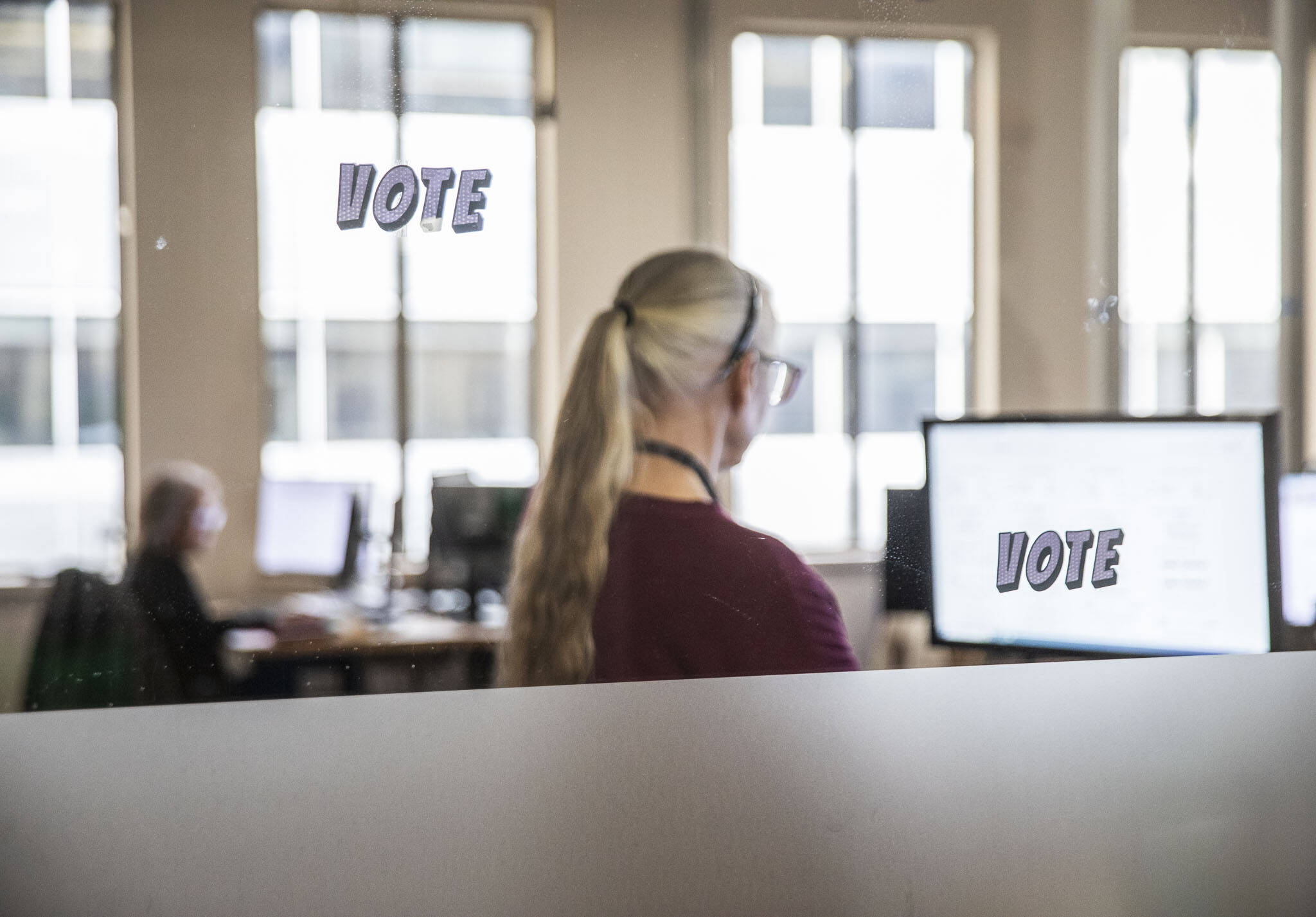 Snohomish County Elections employees check signatures on ballots on Oct. 29 in Everett. (Olivia Vanni / The Herald)