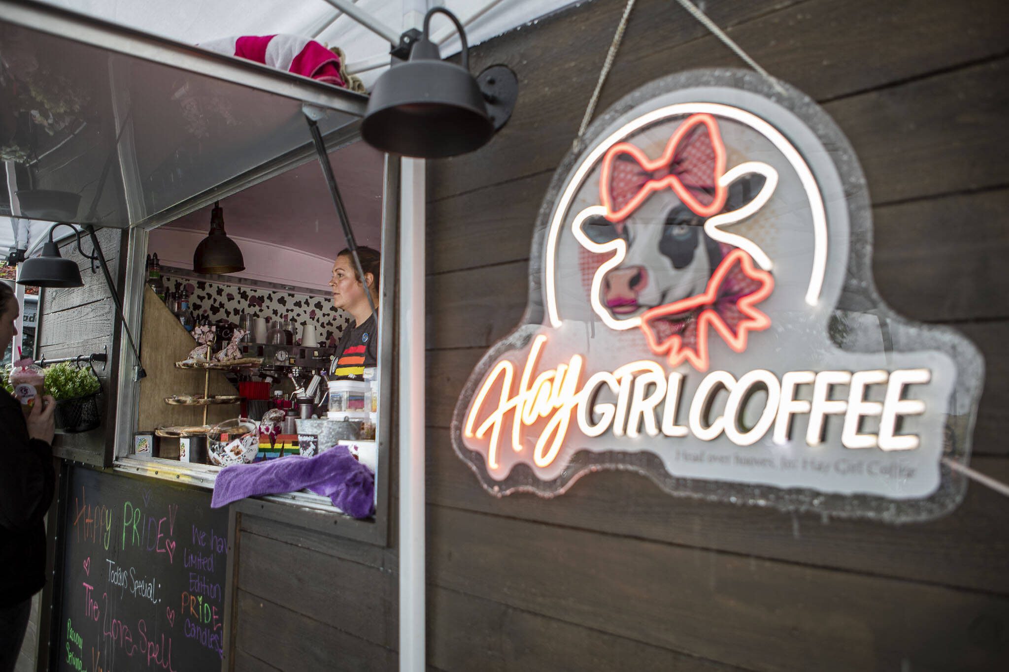Melinda Grenier serves patrons at her coffee truck called Hay Girl Coffee during the third annual Arlington Pride event in Arlington on June 2. (Annie Barker / The Herald)