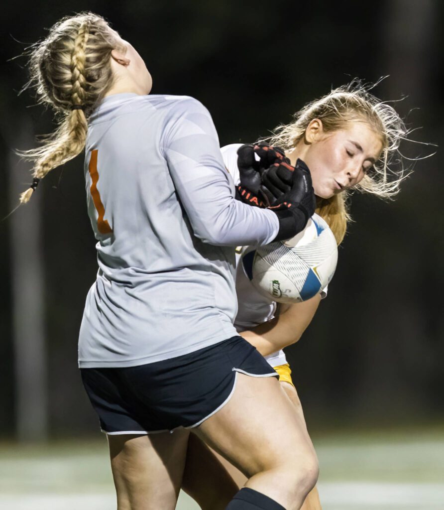 Shorecrest’s Sarah Ehrhart collides with Monroe’s goalie Brooklyn Krache during the 3A district game on Thursday, Nov. 7, 2024 in Shoreline, Washington. (Olivia Vanni / The Herald)
