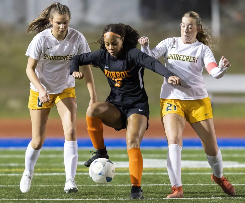 Monroe’s Hope Keller tries to maneuver between Shorecrest’s Kai Johnson and Ezzie Fogg during the 3A district game on Thursday, Nov. 7, 2024 in Shoreline, Washington. (Olivia Vanni / The Herald)
