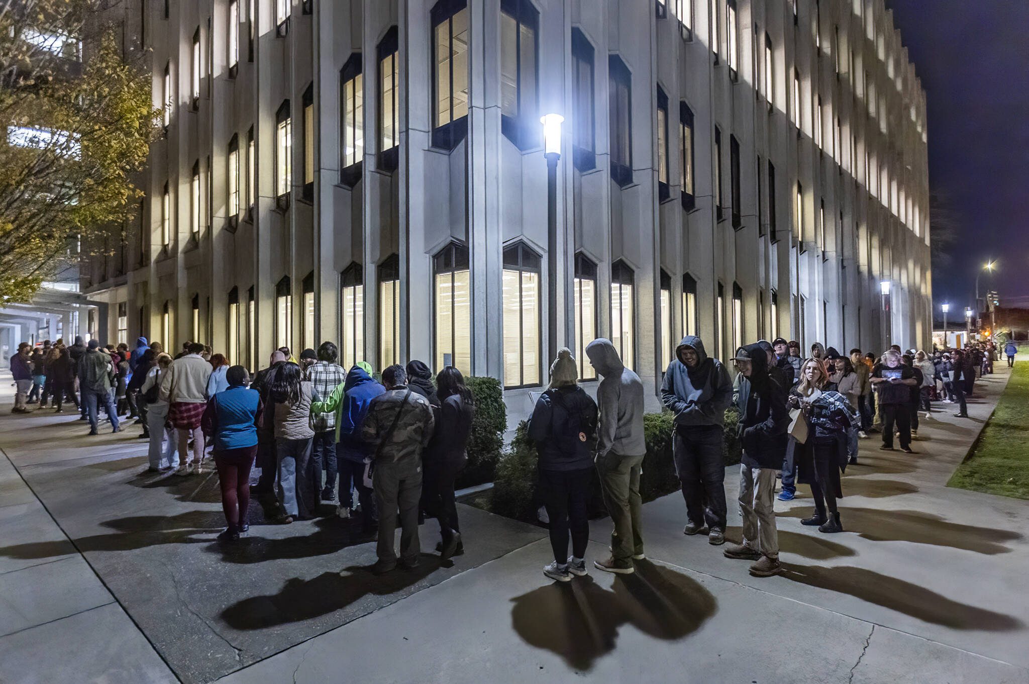 The line for the Snohomish County Auditor’s Office extends around the Admin West building and onto Pacific Avenue Election Day as people wait for same-day registration, ballot issuance and accessible voting services on Nov. 5 in Everett, Washington. (Olivia Vanni / The Herald)