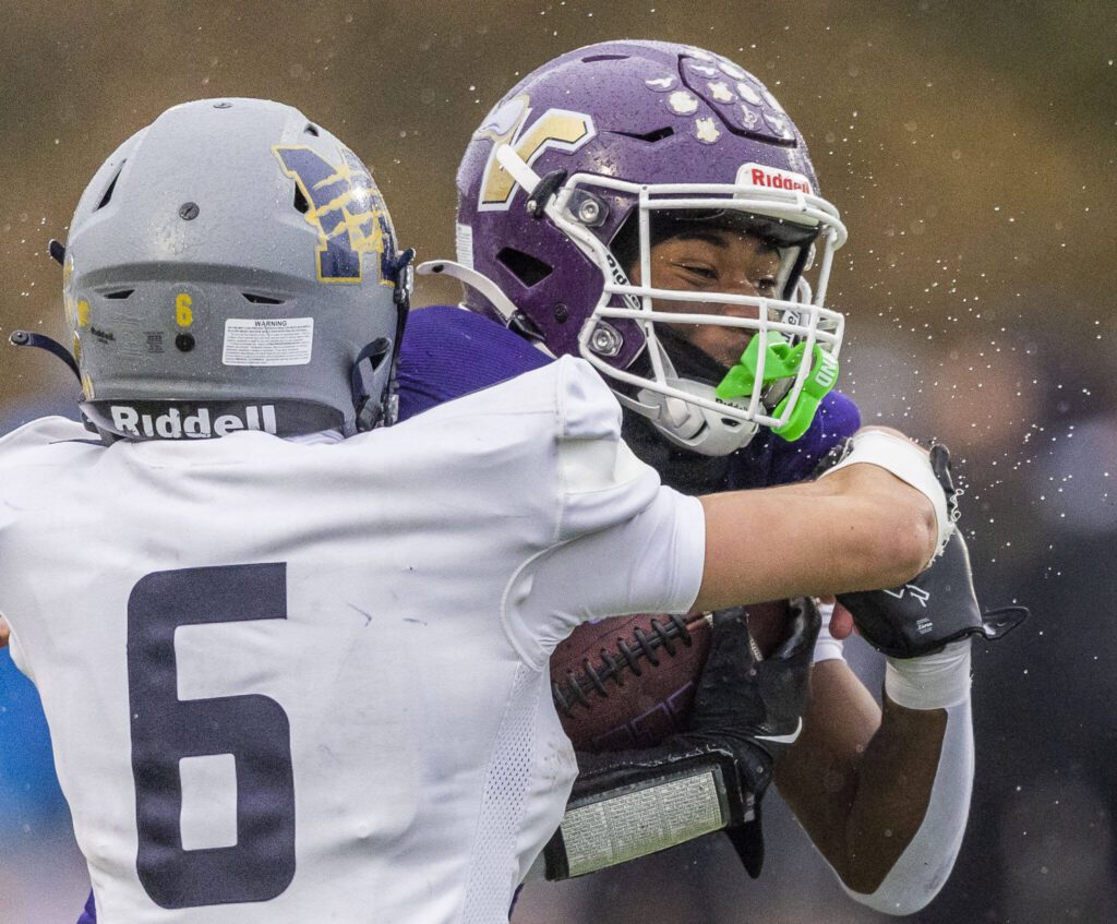 Water sprays off of Lake Stevens’ Jay Ferrell as he is tackled during the 4A state playoff game against Mead on Saturday, Nov. 16, 2024 in Lake Stevens, Washington. (Olivia Vanni / The Herald)
