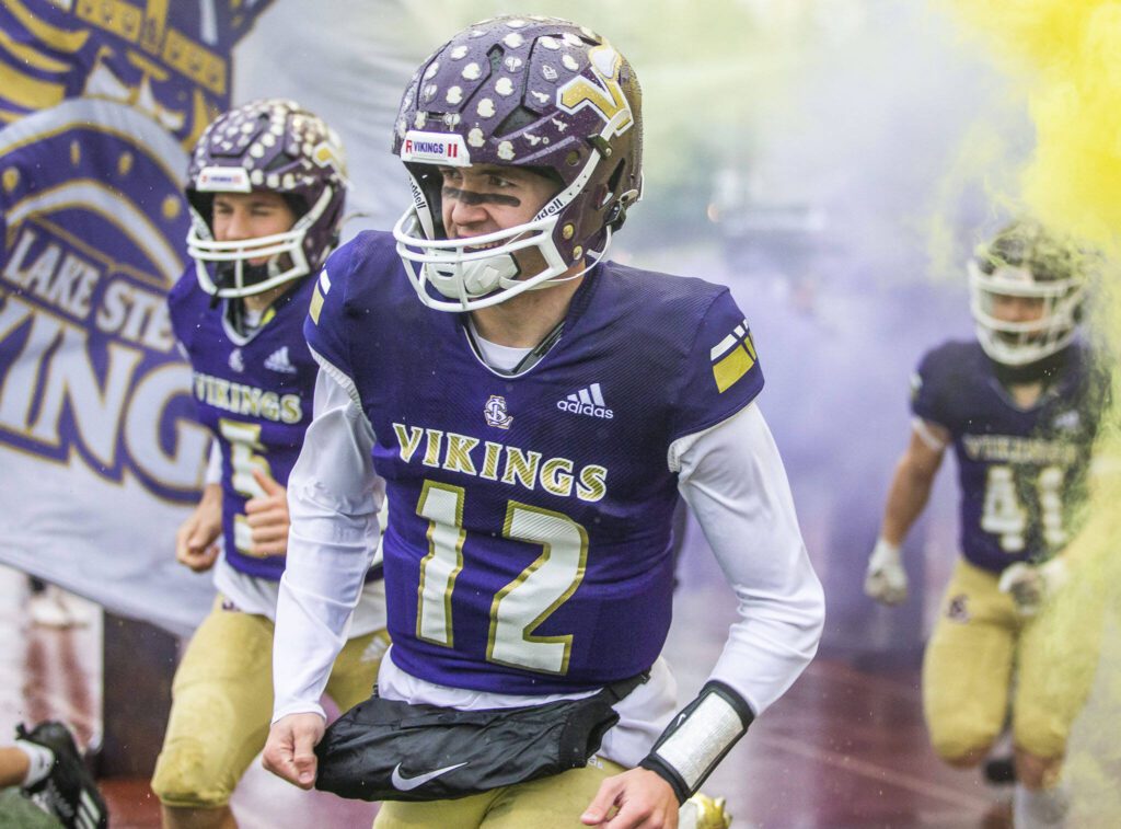 Lake Stevens’ Kolton Matson runs onto the field with his teammates before the start of the 4A state playoff game against Mead on Saturday, Nov. 16, 2024 in Lake Stevens, Washington. (Olivia Vanni / The Herald)
