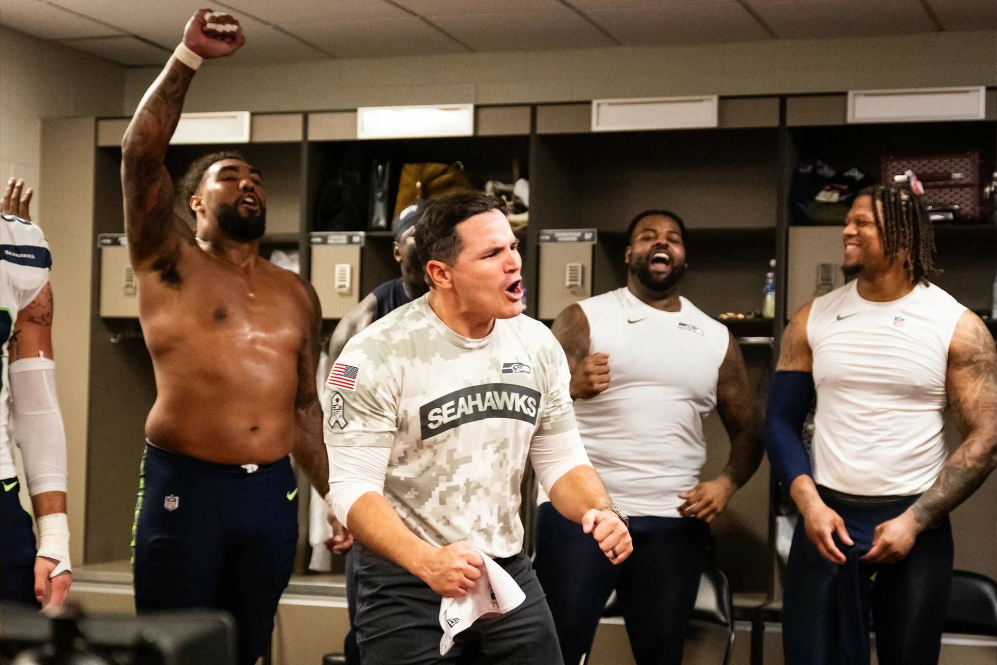 Seahawks coach Mike Macdonald celebrates with players in a Levi’s Stadium locker room after Seattle’s 20-17 victory at San Francisco on Sunday, Nov. 17. (Photo courtesy of Rod Mar / Seattle Seahawks)