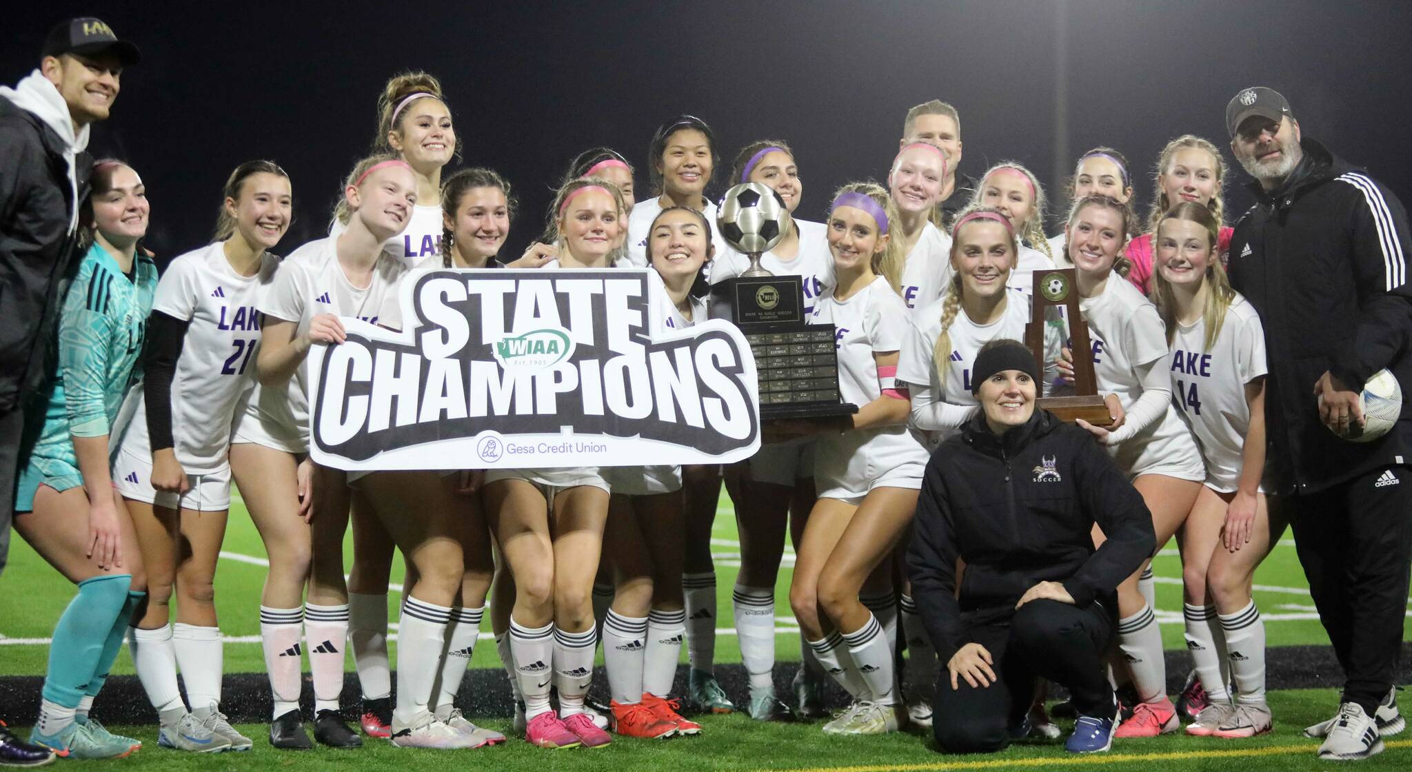 Players and coaches for the eighth-seeded Lake Stevens High School girls soccer team celebrate their 1-0 victory against second-seeded Woodinville in the Class 4A state title game at Sparks Stadium in Puyallup, Wash., on Saturday, Nov. 23, 2024. This marked the first state title in program history for the Vikings. (Taras McCurdie / The Herald)