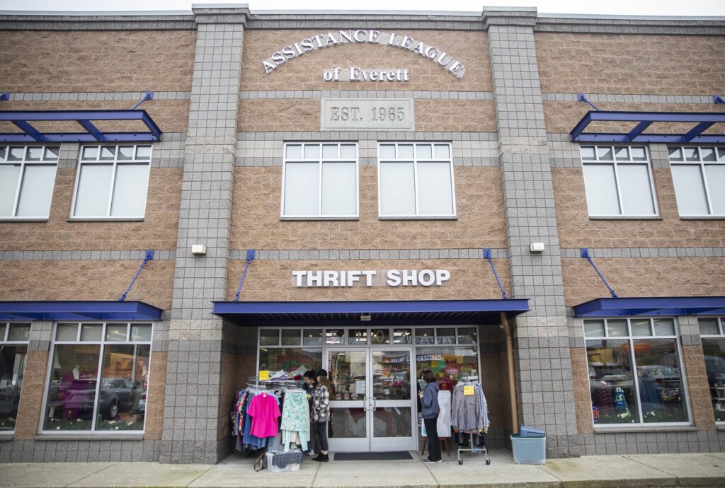 People browse the outside racks at the Assistance League of Everett’s Thrift Store on Monday, Dec. 2, 2024 in Everett, Washington. (Olivia Vanni / The Herald)
