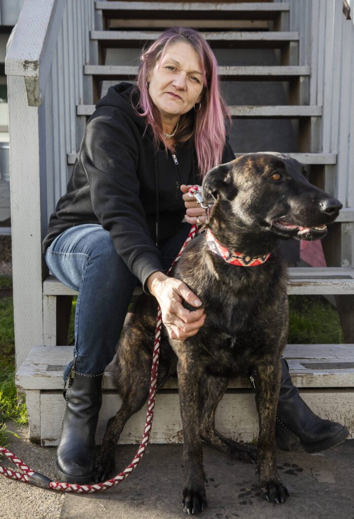 Kristy Kaminshine, who has frequently relied on Esther’s Place since 2021, with her new dog Hazel on Wednesday, Dec. 4, 2024 in Everett, Washington. Kaminshine recently moved into her own one bedroom apartment and finally feels like she is “moving in the right direction”. (Olivia Vanni / The Herald)
