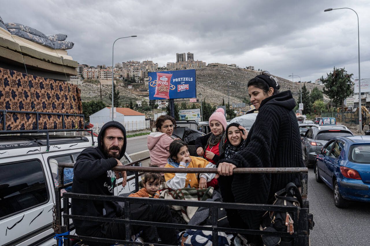 Residents from the south of Lebanon celebrate as they return to their homes, south of Beirut, Nov. 27. A cease-fire meant to end the deadliest war in decades between Israel and the Lebanese militant group Hezbollah officially took effect early Wednesday, less than a day after President Biden announced the deal and Israel approved its terms. (Daniel Berehulak / The New York Times)