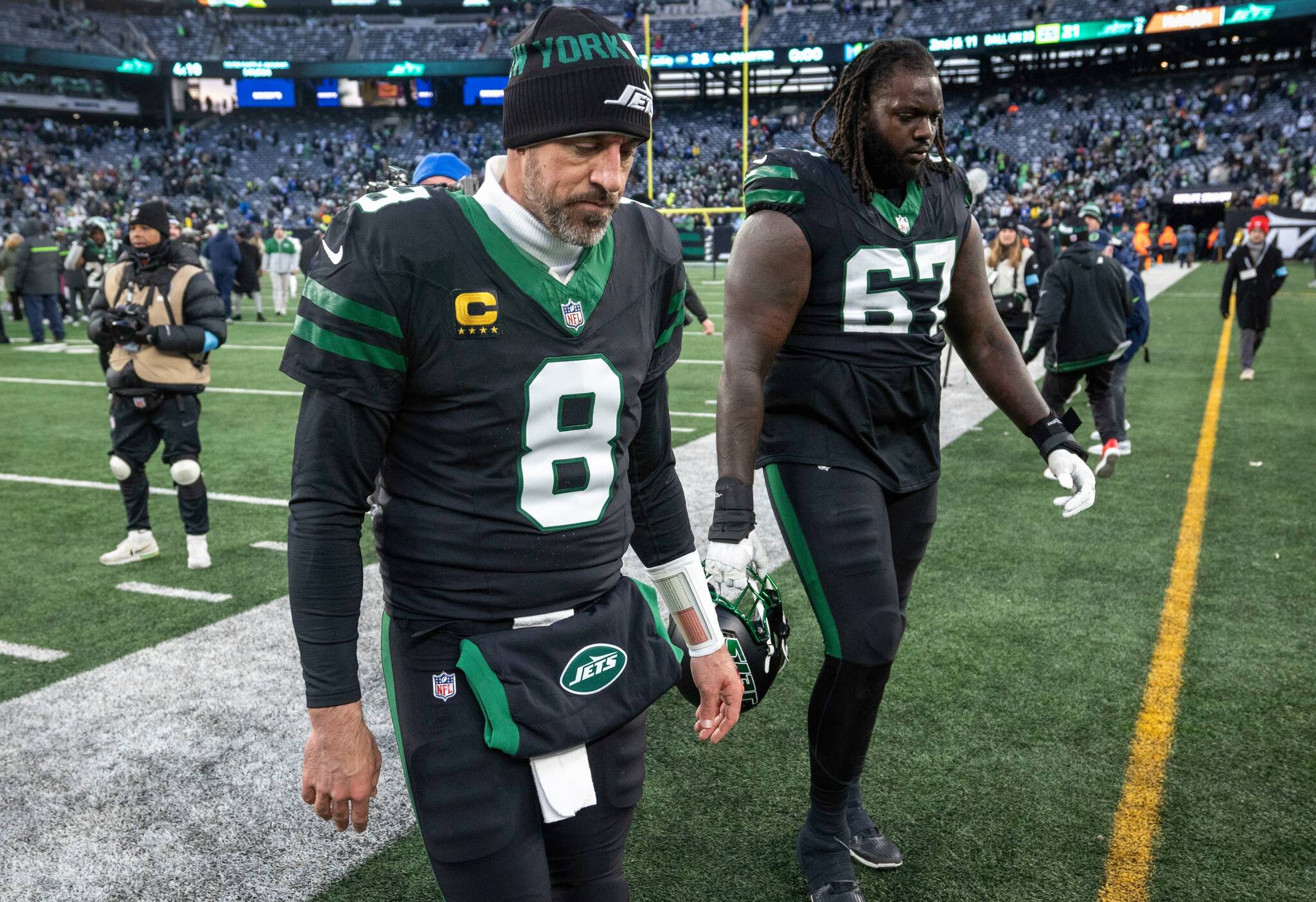 New York Jets quarterback Aaron Rodgers (8) and offensive tackle Carter Warren (67) leave the field after the Jets lost to the Seattle Seahawks, 26-21, Sunday, Dec. 1, 2024, in East Rutherford, N.J. (Andrew Mill / Tribune News Services)