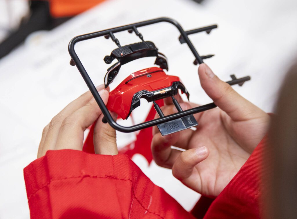 Elizabeth Gonzales, 8, checks to see if her car bumper fits during Toyota Mini Makers Garage on Monday, Dec. 9, 2024 in Marysville, Washington. (Olivia Vanni / The Herald)
