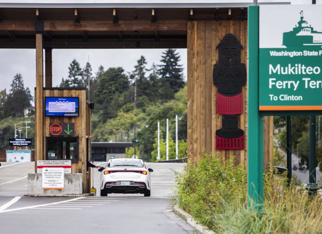 A passenger pays their fare before getting in line for the ferry on Sept. 28, 2023 in Mukilteo, Washington. (Olivia Vanni / The Herald)
