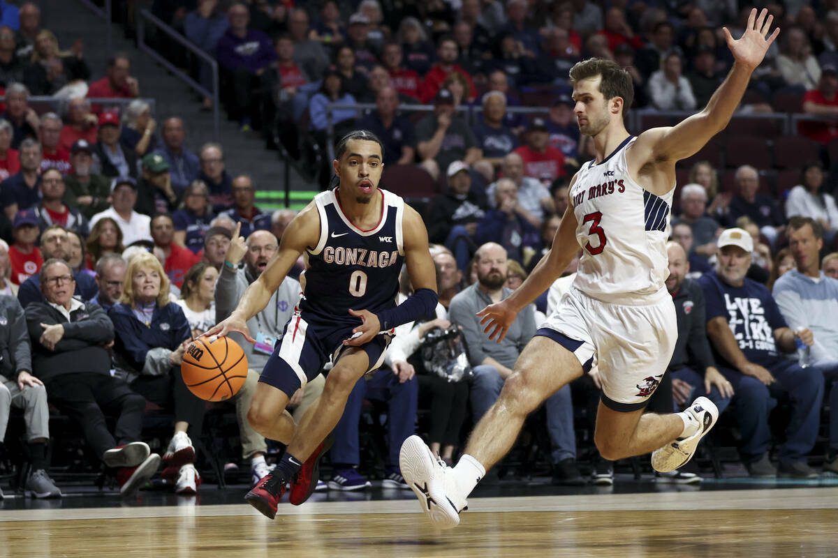 Gonzaga Bulldogs guard Ryan Nembhard (0) drives toward the hoop against St. Mary’s Gaels guard Augustas Marciulionis (3) during the first half of an NCAA college basketball championship game in the West Coast Conference men’s tournament at Orleans Arena on Tuesday, March 12, 2024, in Las Vegas. (Ellen Schmidt / Las Vegas Review-Journal / Tribune News Services)