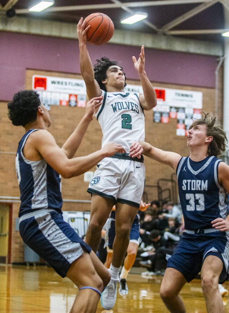 Jackson’s Seamus Williams leaps in the air to make a jump shot during the game against Squalicum on Friday, Dec. 27, 2024 in Mountlake Terrace, Washington. (Olivia Vanni / The Herald)
