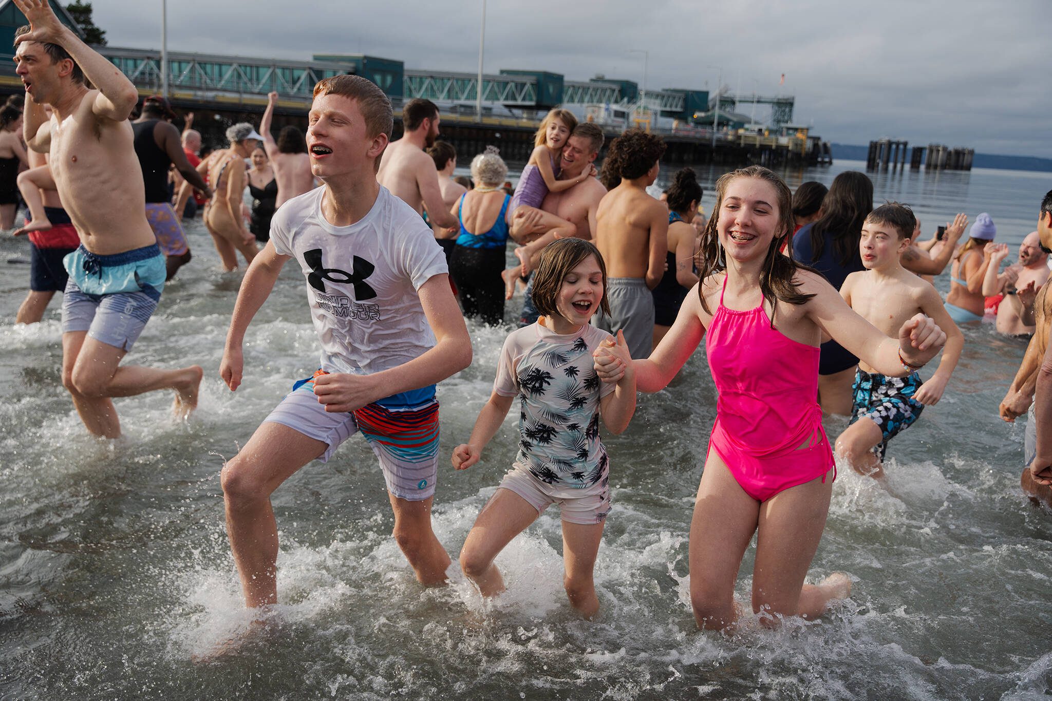 Children emerge from the Polar Bear Plunge on Wednesday, Jan. 1, in Edmonds, Washington. (Will Geschke / The Herald)