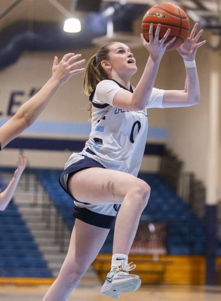 Meadowdale’s Payton Fleishman makes a layup during the game against Archbishop Murphy on Friday, Jan. 3, 2025 in Lynnwood, Washington. (Olivia Vanni / The Herald)
